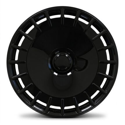 Front-facing commercial product shot of a luxury monoblock forged wheel, highlighting the solid aero center face, gloss black finish, and center-lock style cap.
